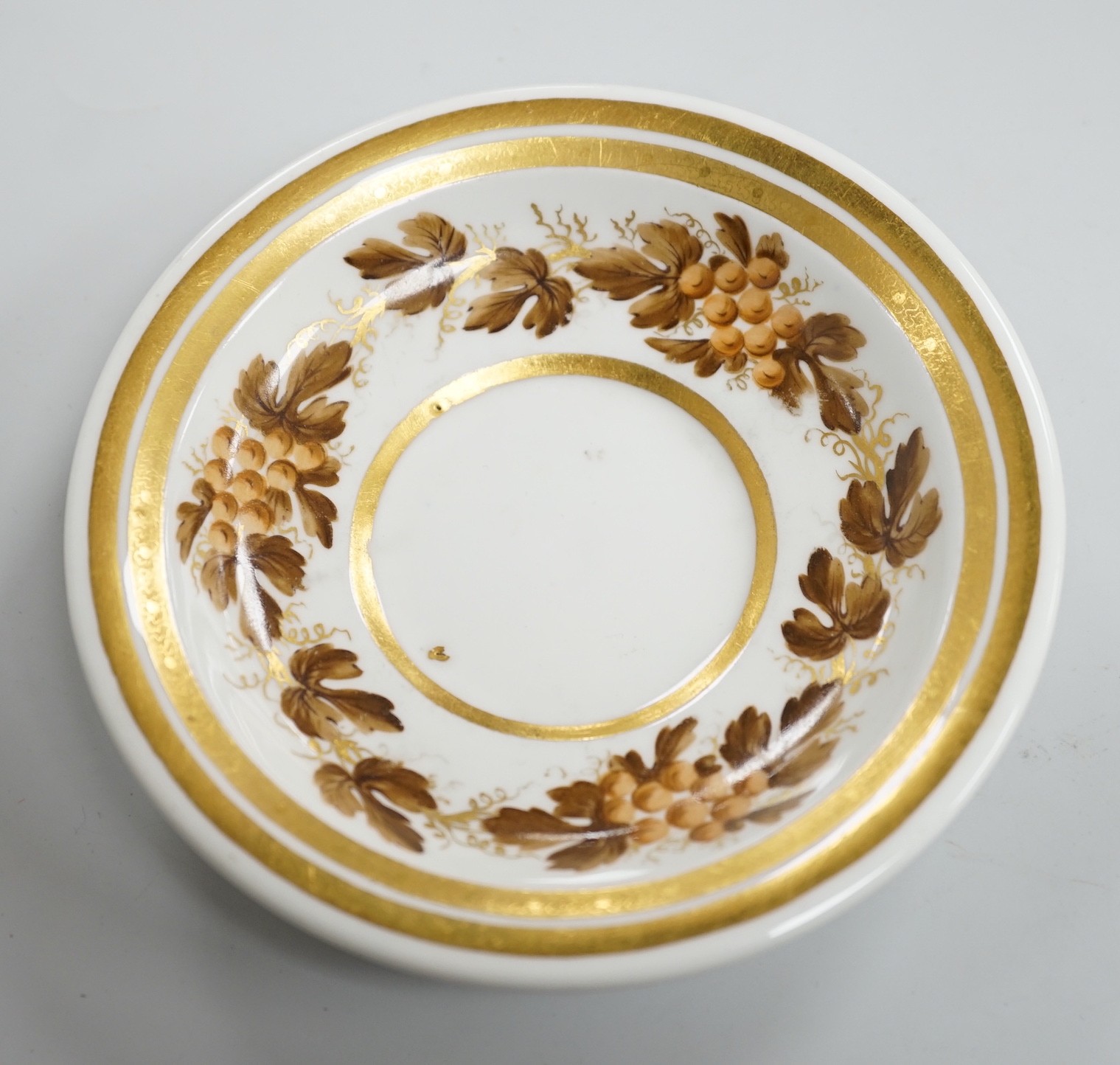 An early 19th century Furstenburg brown and white cup and saucer, saucer diameter 13cm